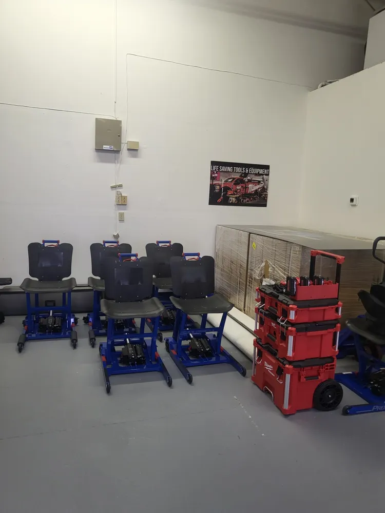 Finished Pro 500 chairs lined up beside Milwaukee Packout battery cases