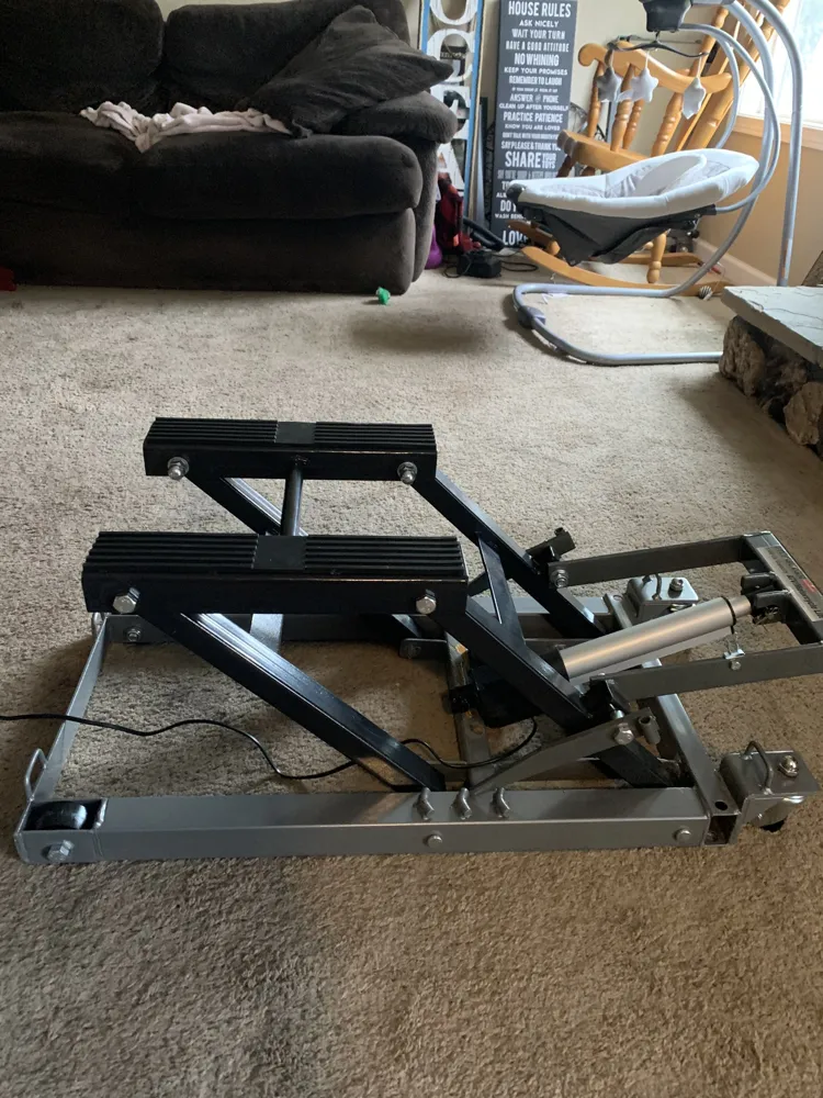 The first steel scissor-lift prototype on a living room floor