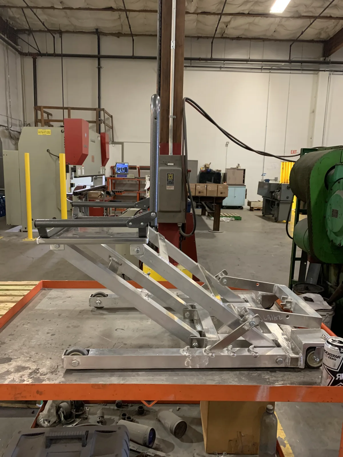 Aluminum scissor-lift prototype on a shop workbench