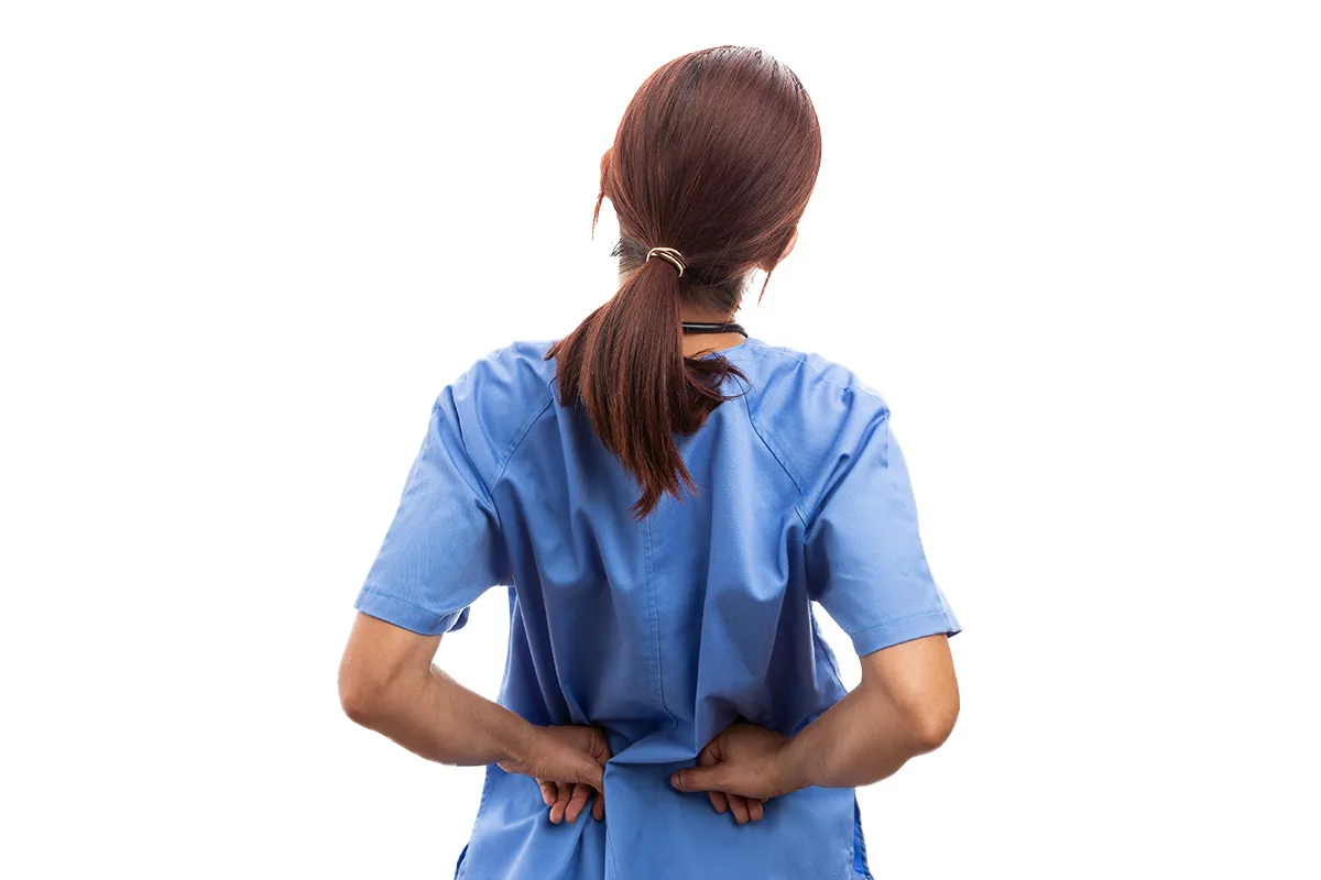 A caregiver holding her lower back after a manual lift injury